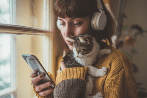Woman listening to music with her kitten
