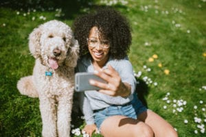Woman taking a selfie with her dog