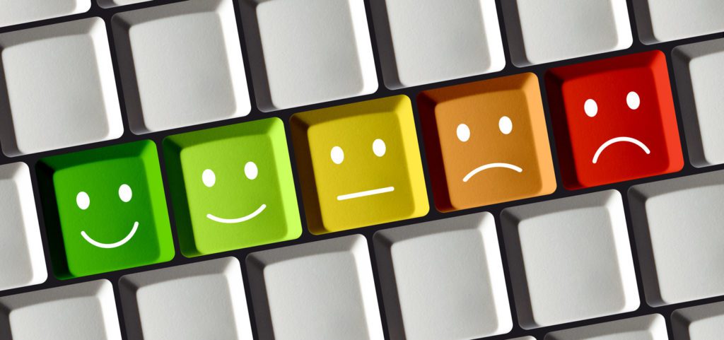 Computer Keyboard with colored keys showing positive and negative emotion from red over yellow to green