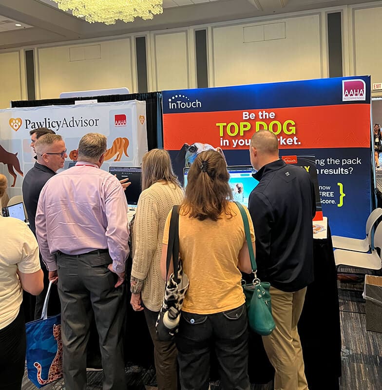 group gathered inside intouch tradeshow booth