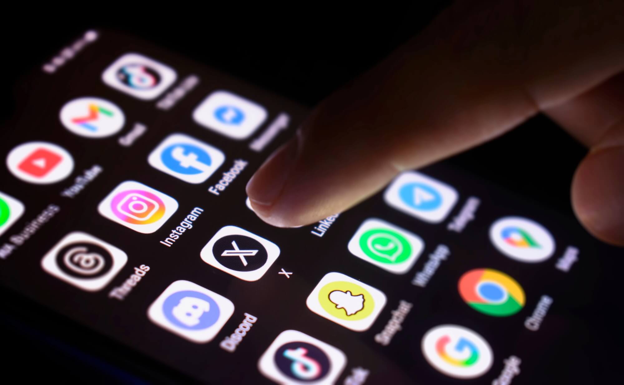 cell phone screen with various app icons including facebook, tik-tok, snapchat, x, instragram