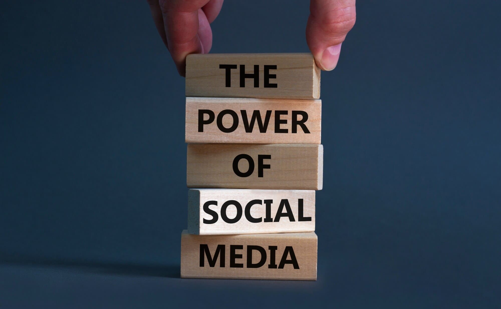 wood blocks stacked with the words the power of social media