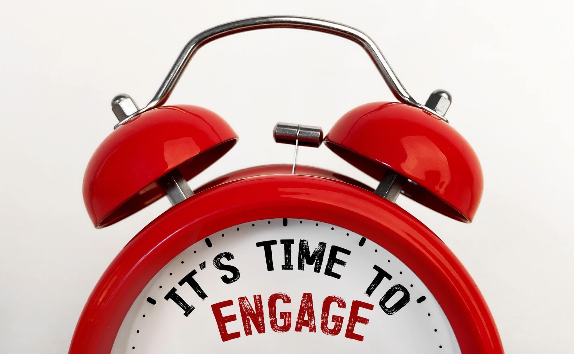 red clock with the words "it's time to engage"