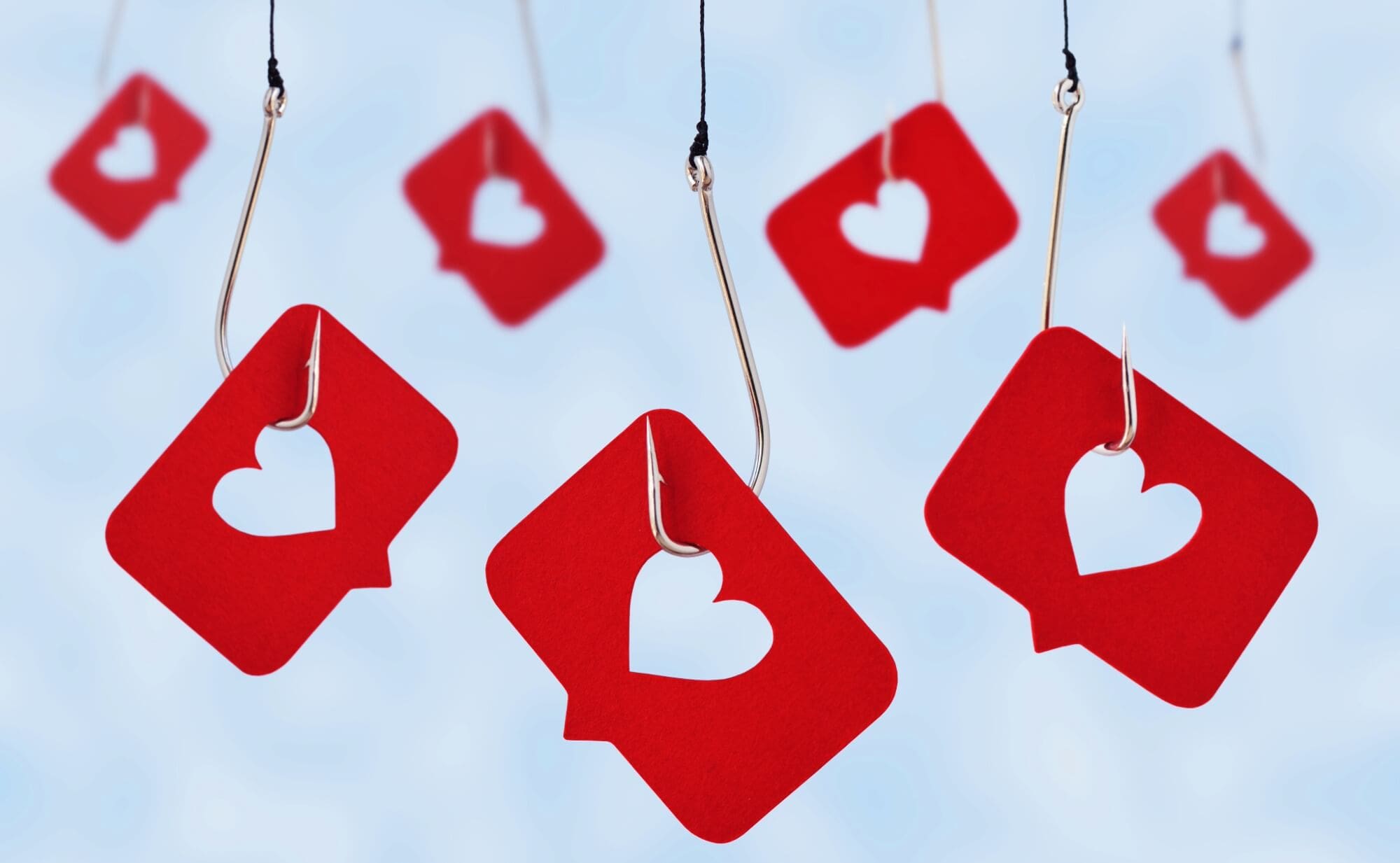 red paper cards with heart cutouts hanging from hooks