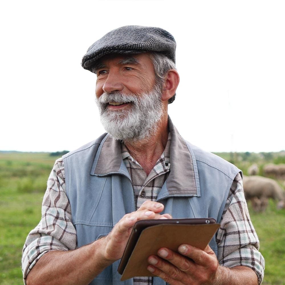happy-farmer-with-livestock-holding-tablet